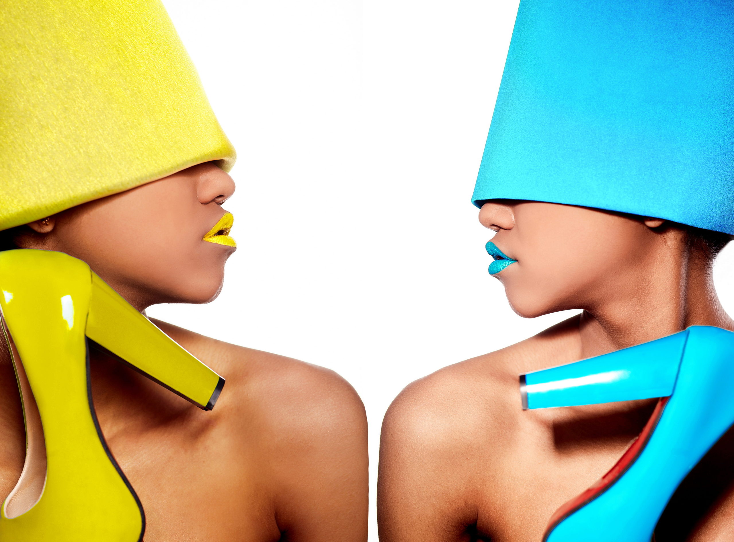 Two women with bright hats and holding shoes for fashion translation and copywriting of products for E-commerce