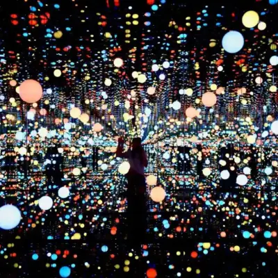 Immersive light installation with vibrant orbs of various colors in a mirrored room, symbolizing skills acquired and brain areas activated through the stages of learning: unconscious incompetence, conscious incompetence, conscious competence, and unconscious competence